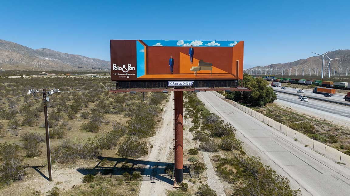 A minimalist Polo and Pan Coachella billboard on a desert highway