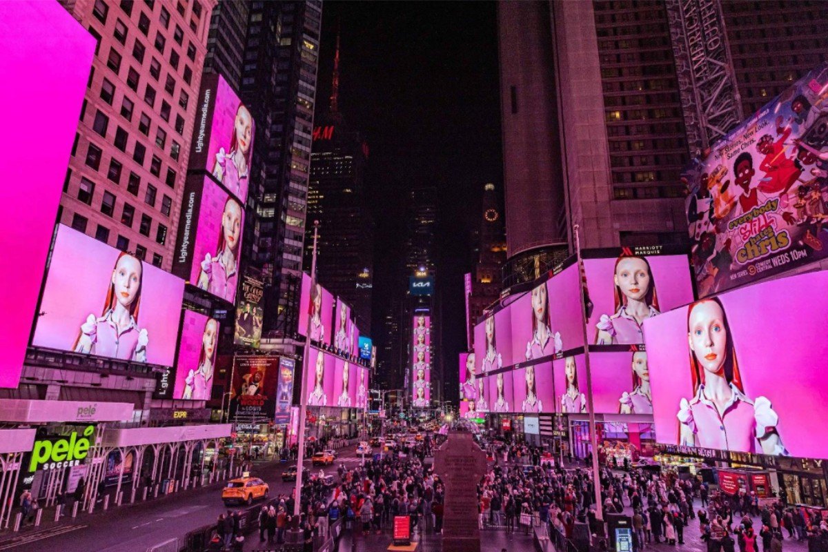 Pink-saturated Times Square billboards at night, all running the same image