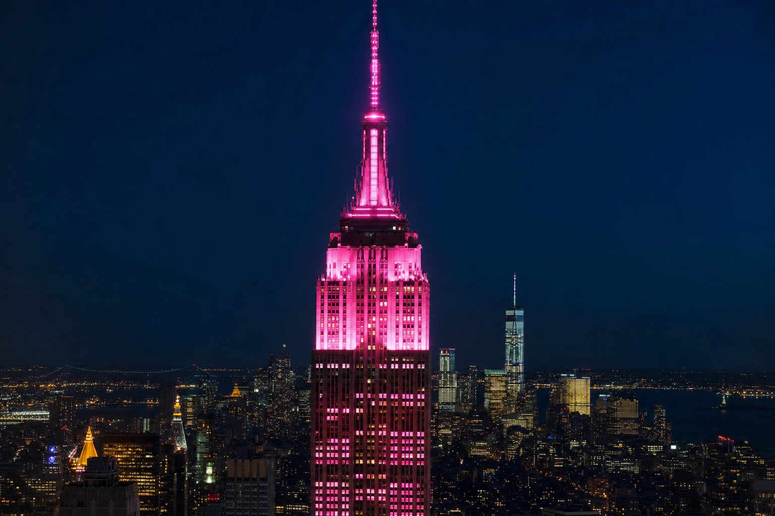 The Empire State Building glowing pink at 9:25 PM for Dolly Parton