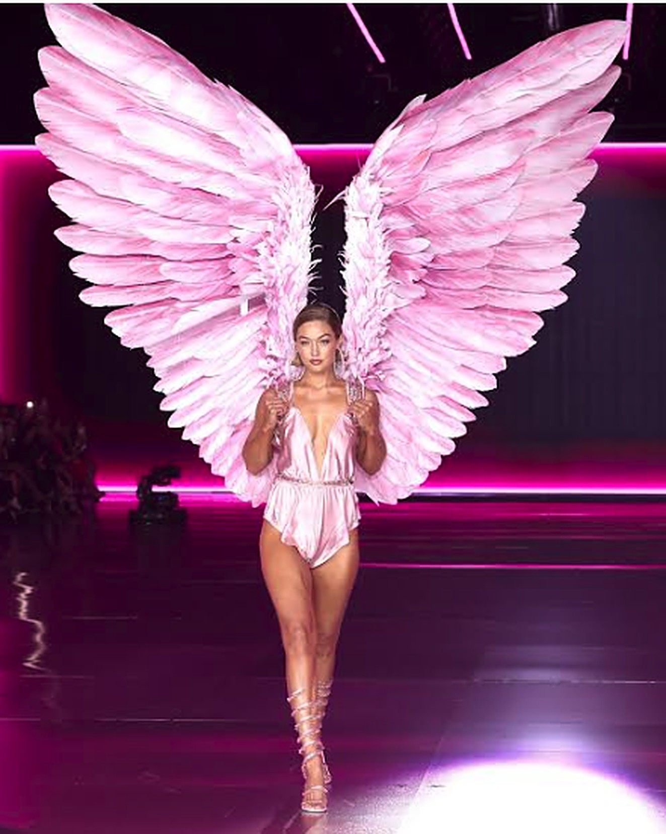 A model in pink angel wings on the Victoria's Secret runway